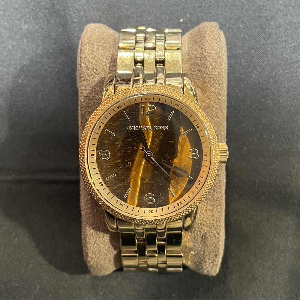 Gold Micheal Kors watch with brown cat eye face